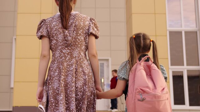 Parents bringing kids to school, Students on the steps, Getting ready for learning, Primary school moment, Children preparing for lesson, Early school hours, Boys reading book, Lively school