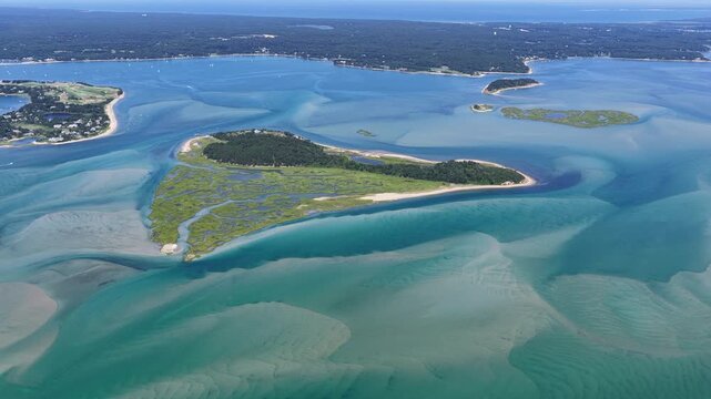 Ocean currents renew shallow water surrounding the salt marsh on Strong Island in Cape Cod's Pleasant Bay. The Atlantic Ocean is continuously reshaping the beaches, channels, and sandbars found here.