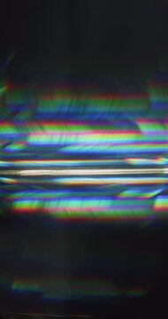 Light ray shining into a glass prism causing an optical effect of a dazzling rainbow of sparkling lights. Lighting reflect creating a visual of a burst of streaks in brilliant shining colors. Loop.