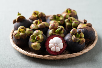 Fototapeta premium Fresh mangosteen in wicker plate, Tropical fruit in Thailand