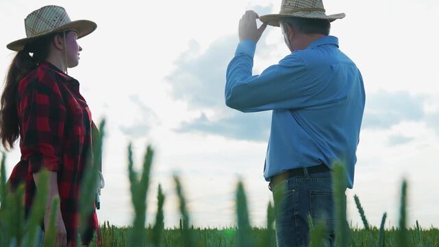 Professional agreement at farm, Farmers meeting at sunrise, Business concluded in nature, Partnership handshake in rural area, Agricultural work friendship, Wheat field cooperation, Rural handshake
