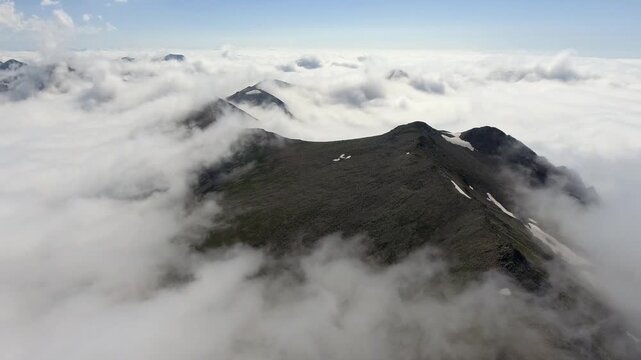 Aerial Zagros Iran mountain peaks rise above clouds with rugged ridges and high altitude drama.