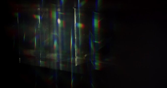 Light ray shining through a prism for angled beams of sparkling shine in brilliant colors. Swirling reflective glass with beaming lights creating visual effect of a brilliant dazzling rainbow. Loop.