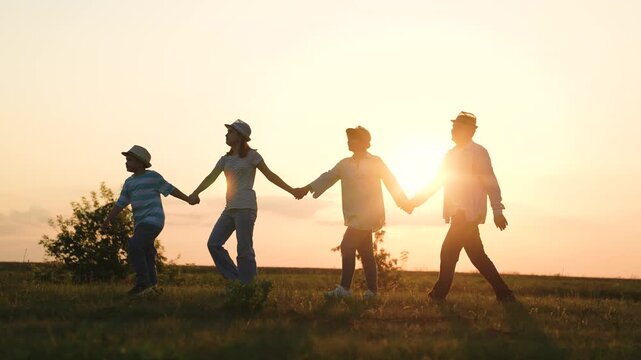 happy family, child holding mother father hand sunset, wife husband friendly team, group people walking nature sunset, supporting each other, people from behind, supportive family environment