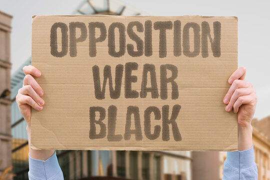 "Opposition Wear Black" Opposition MPs wear black outside the chamber, leading to repeated adjournments inside. OPPOSITION. WEAR. BLACK. ADJOURN. CHAMBER.