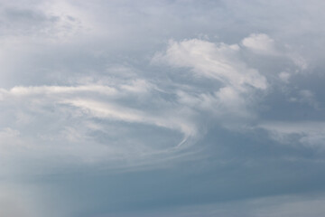 Obraz premium blue sky with a dramatic scattering of white clouds. blue sky background.