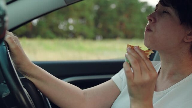 woman girl eating burger car, happy person, Travel meal preparation, Eating fast on the highway, Food on the move, Practical eating solution, Quick snack during journey, One hand burger eating, Real