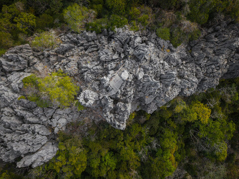 Aerial view of the sharp limestone karst formations and a wooden pathway in the Ankarana Special Reserve, Diana, Madagascar.