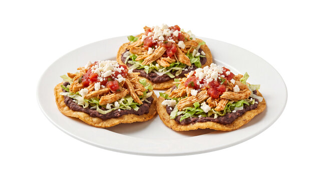 Mexican chicken tostadas with black beans and salsa, crispy corn tortillas on white plate, traditional latin american appetizer