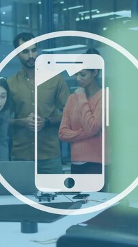 Smartphone icon animation over diverse team collaborating in modern office