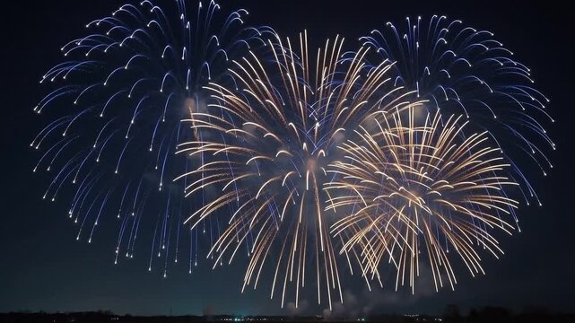 Vibrant fireworks display over night sky motion 4K animation video, colorful pyrotechnic explosions for celebration, festive holiday firework show with gold and blue sparks animated