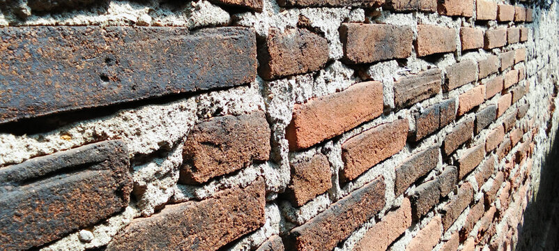 Old red brick wall texture with cement and weathered surface