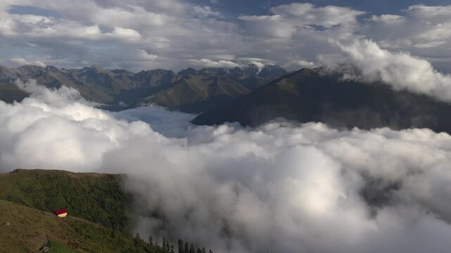 Rize highland meadow and pasture farmland stretch beneath clouds across mountain slopes.