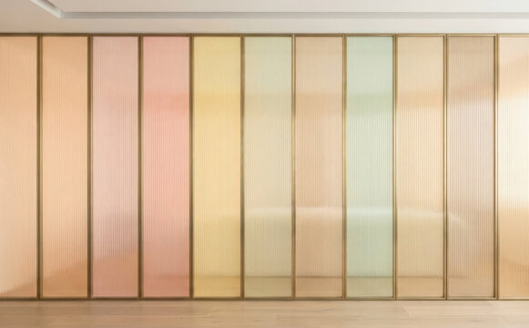 Modern pastel tinted glass sliding door partition with vertical fluted texture for contemporary interior design and stylish room divider concepts