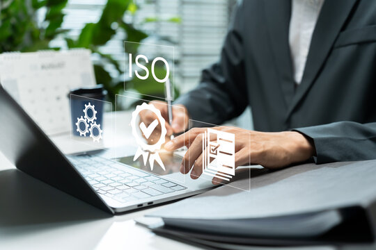 Businessman managing quality standards and ISO certification, representing quality assurance, compliance, process control, certification, guarantee and quality management system.