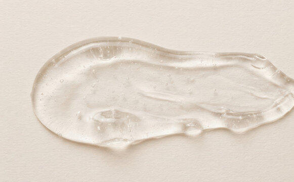 Transparent cosmetic gel texture smear close up for skincare product presentation and beauty branding background