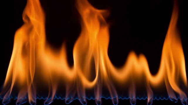 Mesmerizing close up of vibrant orange flames dancing rhythmically above a blue background