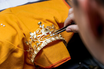 Jeweler Hand Using Tweezers to Set Fresh Pearls on Luxury Gold Tiara Crown, Handmade Jewelry Craftsmanship © younsse