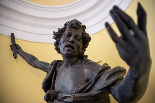 Portrait with the expression of a wooden ebony angel statue.