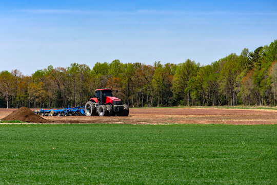 Working farm. Ground preparation. Agricultural process. Rural business. Modern agriculture. Farm operation. Land management. Countryside work. Sustainable farming.