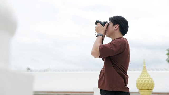 Man taking pictures with vintage film camera
