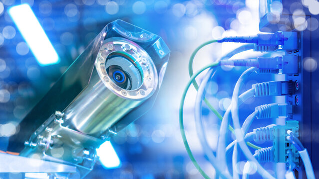 Security technology. Surveillance camera monitors network server cables for cybersecurity, data protection and digital infrastructure control.
