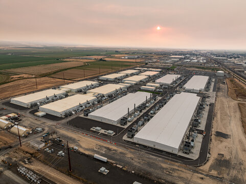 Aerial view of Vantage Data Centers facility with large white industrial buildings and cooling units surrounded by agricultural fields in Quincy, Washington, United States.