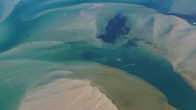 Currents from the North Atlantic Ocean continuously shape the sand banks and beaches of Cape Cod, Massachusetts. The entire peninsula is in constant movement due to its geologic makeup of mostly sand.