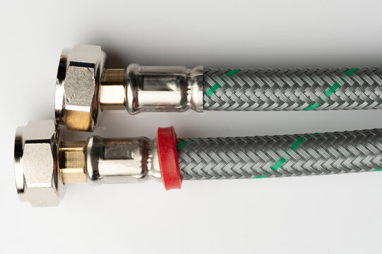 Close up of metal and braided hoses for plumbing use