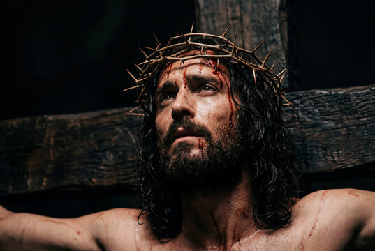 Crucified man wearing a crown of thorns on the wooden cross