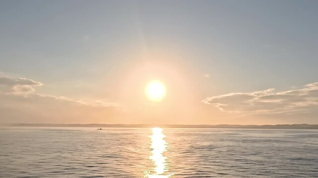 Majestic wide angle view of dazzling golden sunbeams illuminating the open ocean at dawn