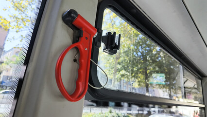 Red safety device near bus window in urban area © Towfiqu Barbhuiya 