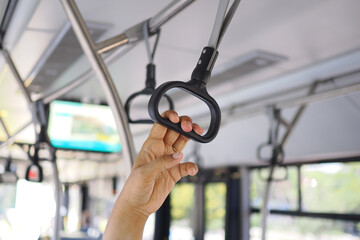 Hand holds onto a bus grab rail while riding © Towfiqu Barbhuiya 