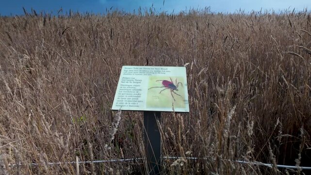 Sign warns about tick bites and gives prevention tips for visiting grassy areas in Fort Bragg Mendocino County California