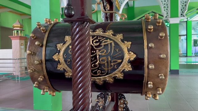 Traditional wooden bedug drum with Arabic calligraphy in mosque