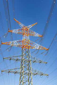 electricity pylon near the airport painted in red and white at the top to indicate danger to the landing and starting aircrafts