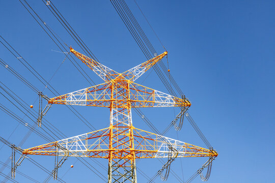 electricity pylon near the airport painted in red and white at the top to indicate danger to the landing and starting aircrafts