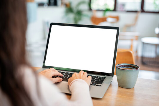 Work from home, online business, and remote working concept: Woman typing on laptop with empty screen mockup for website design