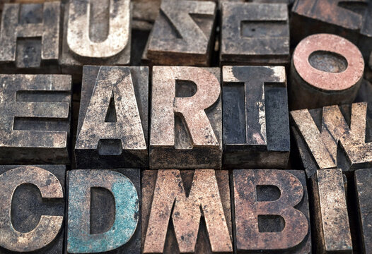 Vintage metal printing blocks with old letters arranged in a rustic typography display