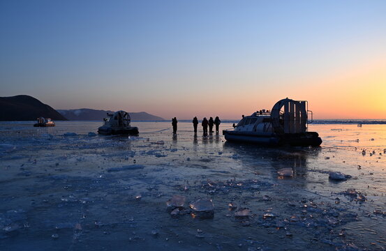Tourists greet the winter dawn on Lake Baikal. Olkhon Gate Strait