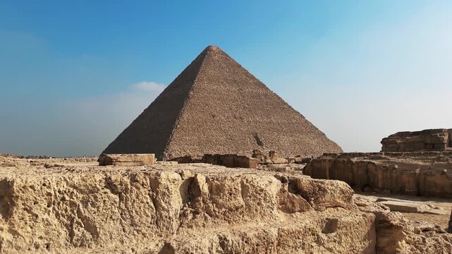 Great Pyramid Seen from the Ancient Ruins on the Giza Plateau Necropolis. Rising up cinematic motion