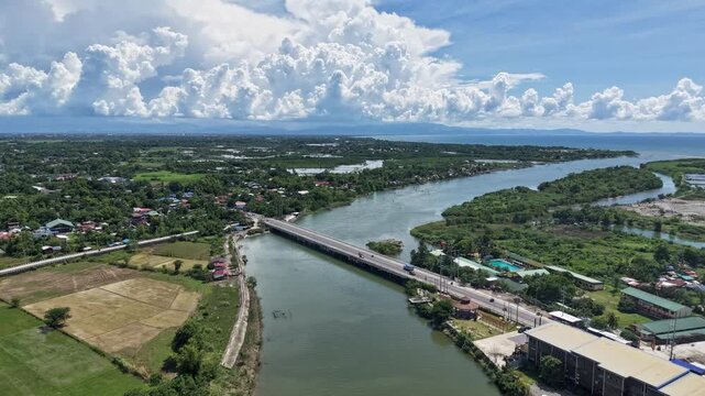 Aerial forward flight hyperlapse over the Cayanga River and Bridge in San Fabian, Pangasinan, Philippines