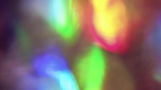 Defocused luminous reflection. Bright light. Yellow green blue color vibrant radiant texture optical flash on abstract illuminated visual background.