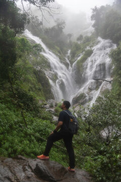 Hiker asian happy feeling freedom good and strong weight victorious facing on the natural mountain. Travel Concept