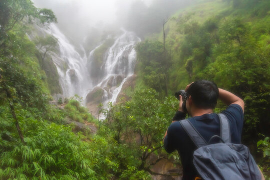 Hiker asian happy feeling freedom good and strong weight victorious facing on the natural mountain. Travel Concept