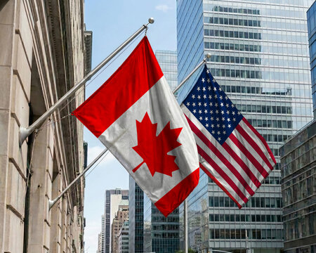 Canada and United States crossed national flags waving against a blue sky, representing bilateral relations and diplomacy.