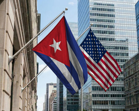 Cuba and United States crossed national flags waving against a blue sky, representing bilateral relations and diplomacy.