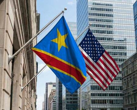 DR Congo and United States crossed national flags waving against a blue sky, representing bilateral relations and diplomacy.