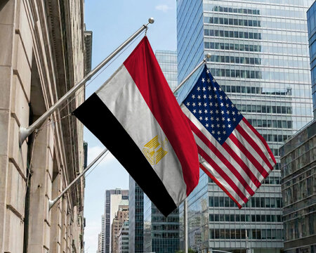 Egypt and United States crossed national flags waving against a blue sky, representing bilateral relations and diplomacy.