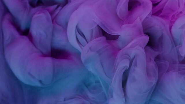 Ink drop. Paint background. Defocused purple blue colorful glitter texture fume vapor splash spreading on acrylic art abstraction.